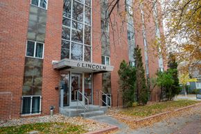 Denver apartment for rent - a brick building with a sign in front of it