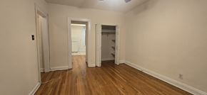 Chicago apartment for rent - A room with wooden floors and white walls.