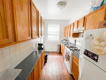 Evanston apartment for rent - A kitchen with wooden cabinets and a white refrigerator.