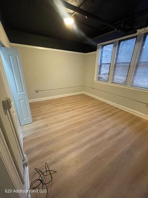 Chicago apartment for rent - the living room of a house with wooden floors and a black ceiling