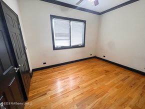 Chicago apartment for rent - the living room of a house with wood floors and a window