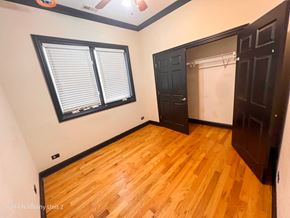 Chicago apartment for rent - a bedroom with wood floors and a closet and a window