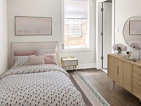 Chicago apartment for rent - a bedroom with a bed and a dresser and a window