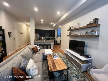 Chicago apartment for rent - A living room with a grey couch and a wooden coffee table.