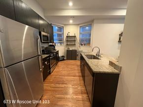 Chicago apartment for rent - A kitchen with wood floors and stainless steel appliances.
