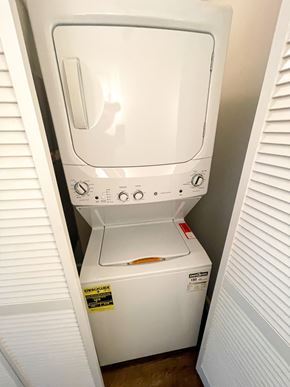 Chicago apartment for rent - A white dryer and washer are sitting in a small space.