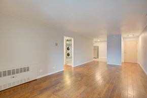 Denver apartment for rent - A room with wooden floors and white walls.