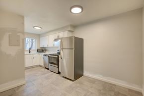 Denver apartment for rent - A kitchen with a refrigerator, microwave, and oven.