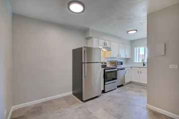 Denver apartment for rent - A kitchen with a refrigerator, oven, and microwave.
