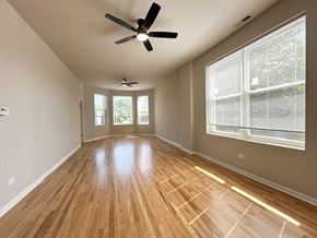 Chicago apartment for rent - A room with wooden flooring and a ceiling fan.