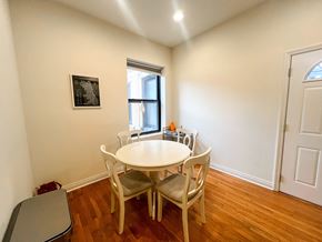 Chicago apartment for rent - A white table with four chairs is in a room with a window.
