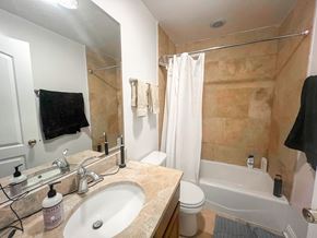 Chicago apartment for rent - A bathroom with a sink, toilet, and bathtub.