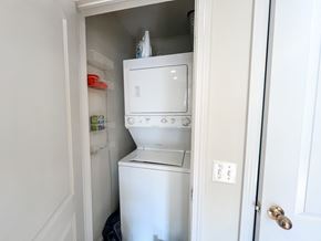 Chicago apartment for rent - A white washing machine is in a small space in a home.