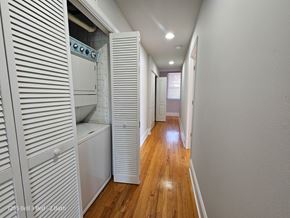 Chicago apartment for rent - a laundry room with a washer and dryer and a hall to a bathroom