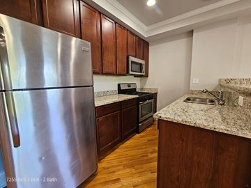 Chicago apartment for rent - a kitchen with stainless steel appliances and granite counter tops