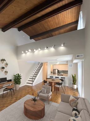 Chicago apartment for rent - A living room with a couch, a coffee table, and a staircase.