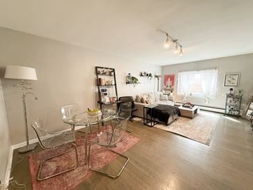 Chicago apartment for rent - A living room with a glass table and chairs.