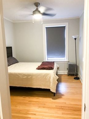 Evanston apartment for rent - a bedroom with a bed and a window and a ceiling fan
