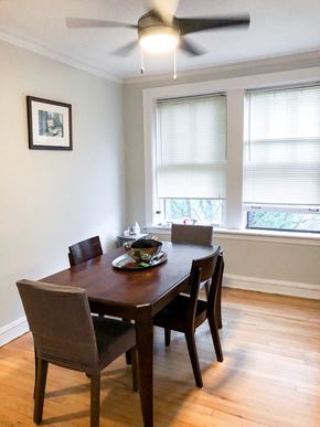 Evanston apartment for rent - a dining room with a table and chairs and a ceiling fan