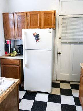 Evanston apartment for rent - a kitchen with a refrigerator and wooden cabinets