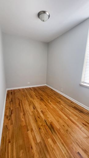 Chicago apartment for rent - A room with wooden flooring and a ceiling light.