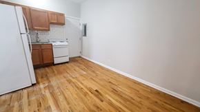 Chicago apartment for rent - A kitchen with wooden floors and white walls.