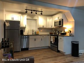 Chicago apartment for rent - A kitchen with a refrigerator, microwave, and oven.