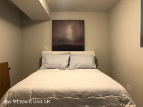 Chicago apartment for rent - A bedroom with a bed, two pillows, and a painting on the wall.