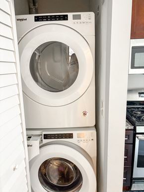 Chicago apartment for rent - A white Whirlpool washing machine is in a cabinet.