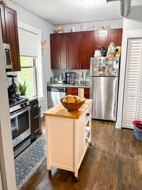 Chicago apartment for rent - A kitchen with a refrigerator, stove, and island.