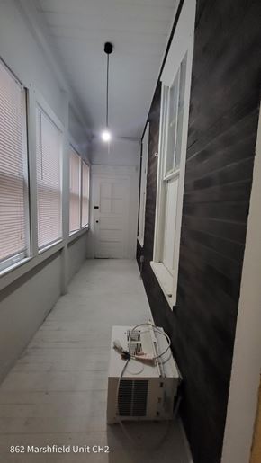 Chicago apartment for rent - A long hallway with a unit in the corner.