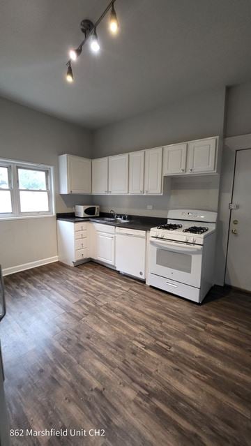 Chicago apartment for rent - A kitchen with white appliances and cabinets.