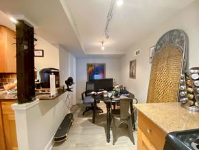 Chicago apartment for rent - A room with a desk, chairs, and a skateboard.
