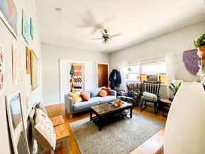 Chicago apartment for rent - A living room with a couch, chairs, and a coffee table.