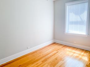 Chicago apartment for rent - A room with a window and wooden flooring.