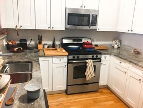 Evanston apartment for rent - A kitchen with a stove top oven and a microwave above it.