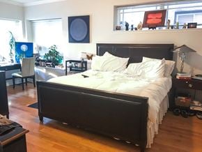 Evanston apartment for rent - A bedroom with a large bed and a desk with a chair.