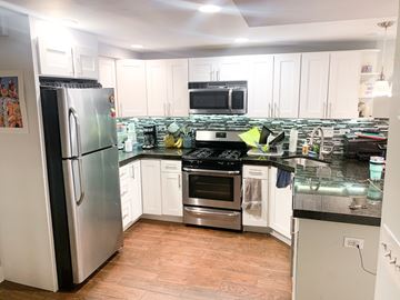 Chicago apartment for rent - A kitchen with a refrigerator, oven, and microwave.