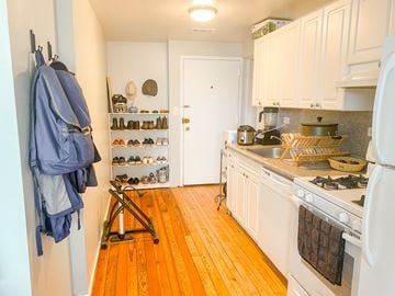 Chicago apartment for rent - A kitchen with a white stove and wooden floors.