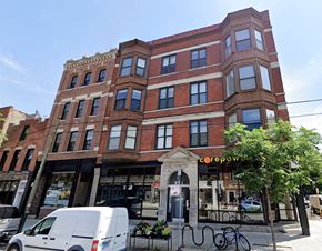 Chicago apartment for rent - a large brick building with a van parked in front of it