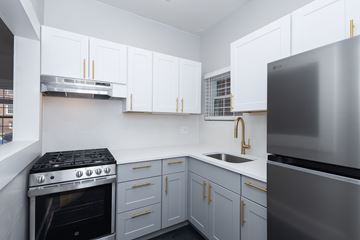 Denver apartment for rent - A modern kitchen with a stainless steel refrigerator and a stove with a stainless steel oven.