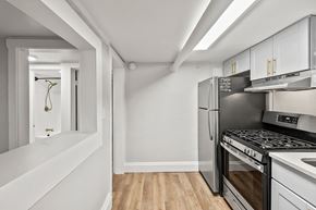 Denver apartment for rent - A kitchen with a stove top oven and a refrigerator.