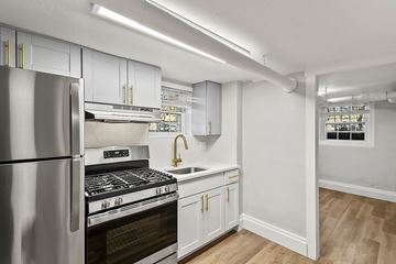 Denver apartment for rent - A kitchen with a stainless steel refrigerator and a stove top oven.