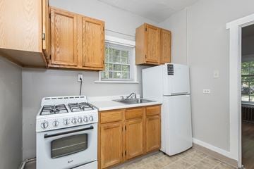 Denver apartment for rent - A kitchen with a white stove and wooden cabinets.