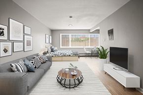 Denver apartment for rent - A living room with a grey couch, a coffee table, and a flat screen TV.