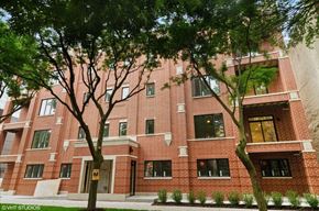 Chicago apartment for rent - A red brick building with trees in front.