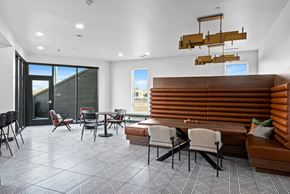 Denver apartment for rent - A modern dining room with a wooden table and chairs.