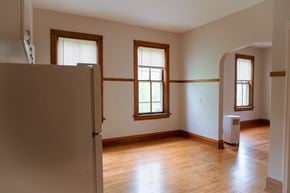 Chicago apartment for rent - A room with wooden floors and two windows.