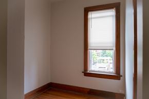 Chicago apartment for rent - A room with a window and wooden floors.