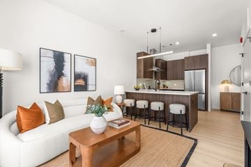 Chicago apartment for rent - A modern living room with a white sofa and a wooden coffee table.